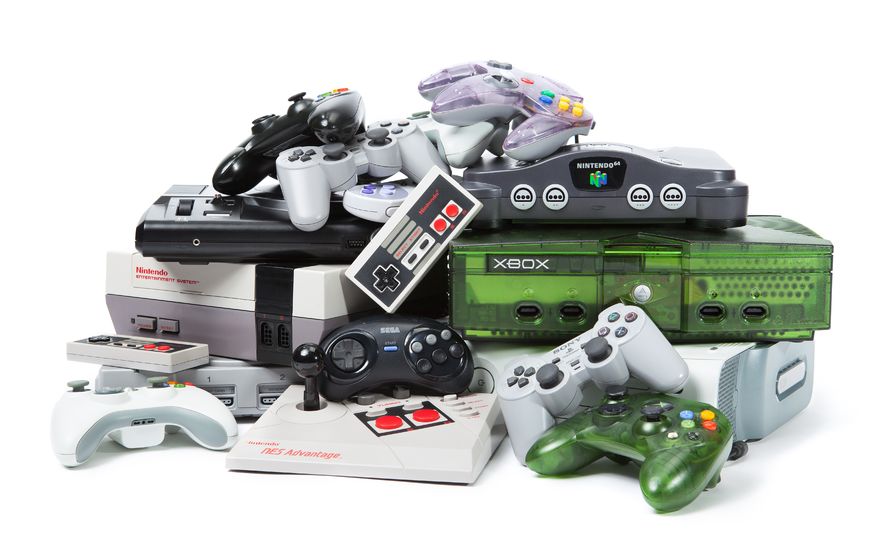 A range of consoles and controllers from SEGA, Nintendo, Sony and Microsoft stacked on top of each other.