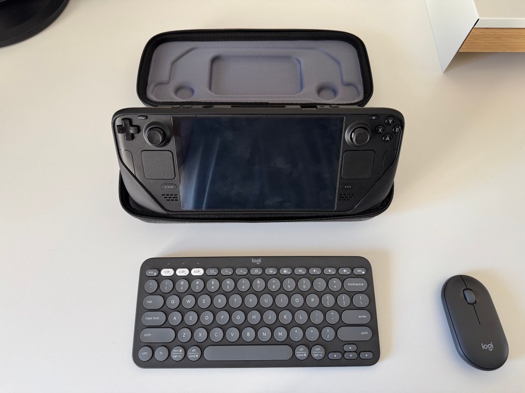 JSAUX Carrying case with its stand ability on show with a Steam Deck OLED and attached Logitech Pebble 2 Combo